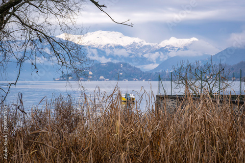 Bild auf Leinwand Panorama of the Lake Orta winter waters and shoreline, with the alps in the background