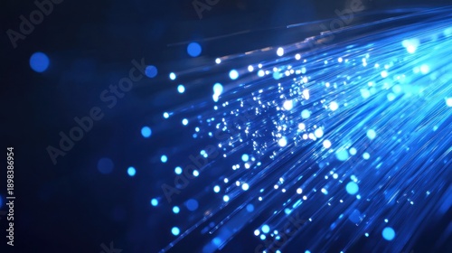 Blue light fiber optics strands, glowing against dark background