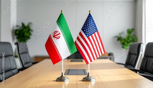 Iranian and U.S. flags placed on a conference table in a modern meeting room, symbolizing diplomatic engagement and international negotiations.