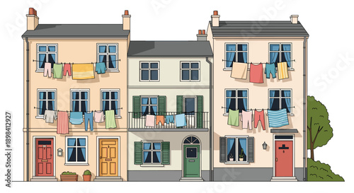 European-style townhouses with colorful laundry hanging on lines between windows for a charming urban scene.