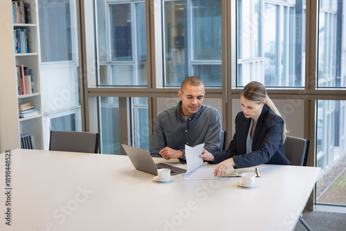Professionals Analyzing Documents at a Meeting