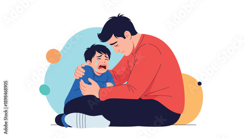 Caring father sitting on the floor and embracing his crying young son to provide comfort and emotional support during a difficult time.