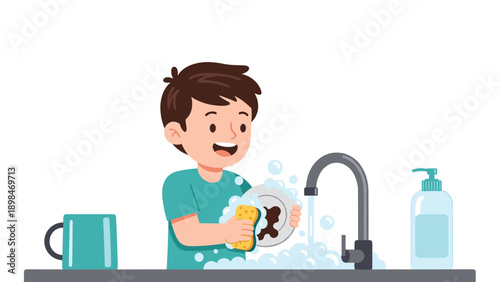 Helpful young boy with a happy expression washes a plate with a sponge and soapy water at a kitchen sink with a faucet.