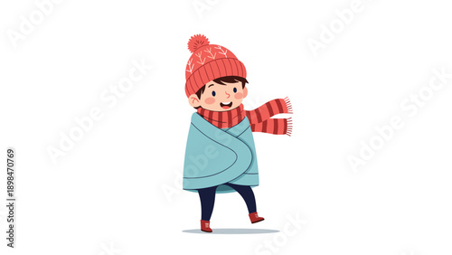 Young boy wrapped in a warm blanket and wearing a red knitted hat and scarf enjoys a cold winter day outdoors with a happy smile.