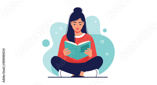 Young woman sitting cross-legged on the floor while being completely absorbed in reading an interesting open book.