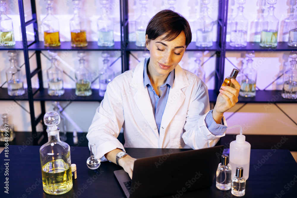© Petro - Female perfumer crating perfumes at her laboratory
