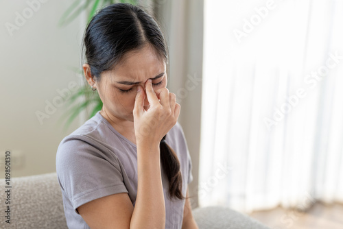Cuadro en lienzo women holding her nose bridge with eyes closed, feeling sinus pain or stress