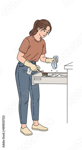 Young woman cleaning kitchen drawer with gloves and cloth  