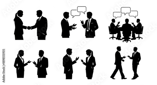 Business professionals in silhouette discussing and shaking hands.