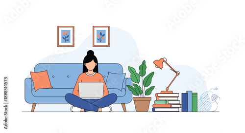 Woman sitting cross-legged on a blue sofa while working on a laptop in a cozy home office or living room environment.