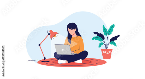 Young woman sitting on a rug and working on her laptop with a desk lamp and a potted plant nearby for cozy remote work or home study concepts.