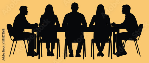 Silhouettes of five people sitting around a table in a meeting