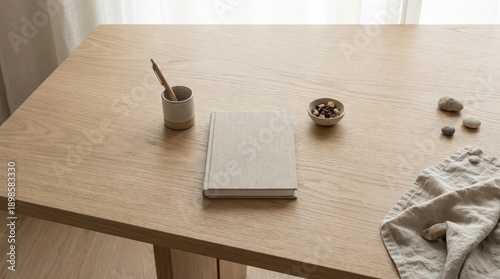 Notebook pen and snack on a wooden desk surface