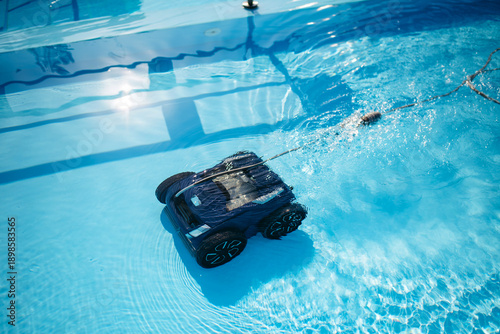 Canvas Print Robotic pool cleaner working underwater to keep swimming pool clean
