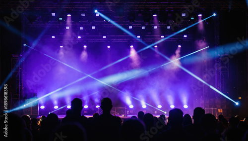 Wallpaper Mural Bright purple stage lighting beams over dark concert audience silhouettes creating exciting atmosphere of anticipation and energy for live music entertainment performance event at night club venue Torontodigital.ca