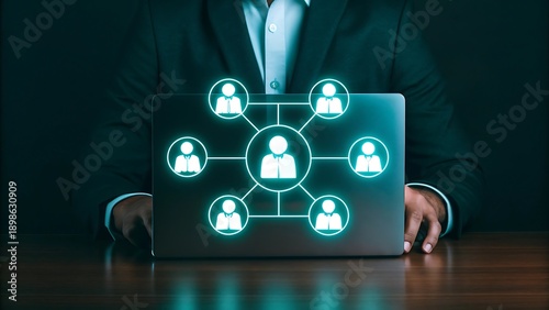 Professional using a laptop displaying a network of interconnected profiles