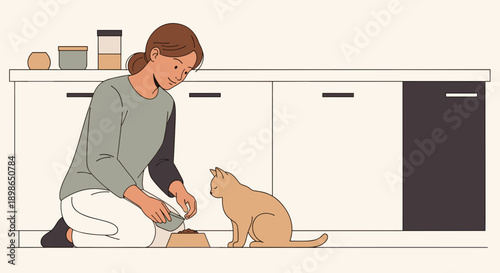 Woman feeding cat while kneeling in modern kitchen environment  