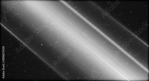 Abstract black and white image with diagonal lines and light streaks creating a futuristic and mysterious atmosphere.