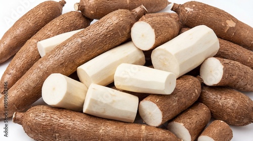 Pile of Fresh Raw Cassava Roots, Both Whole and Peeled, Showcasing a Natural Food Ingredient for Various Culinary Applications and Starch Production