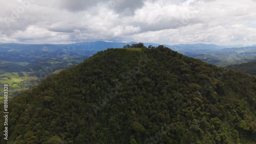 aerial and circular view of a mount in the middle of the Atlantic Forest in Sao Paulo coast in Brazil