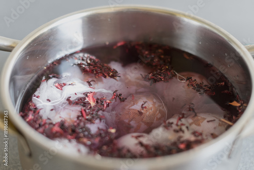 фотографія A stainless steel pot filled with boiling water and dried hibiscus flowers