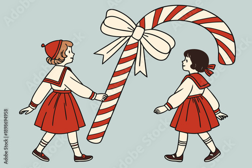 Two children dressed in festive attire holding a giant candy cane