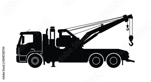 A stark black silhouette depicts a heavy duty tow truck with a raised boom and hook showcasing industrial strength silhouette