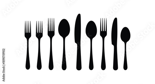 A collection of flatware including forks spoons and knives are displayed in a stark black arrangement silhouette high quality professional