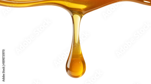 Golden honey dripping smoothly in a single drop
