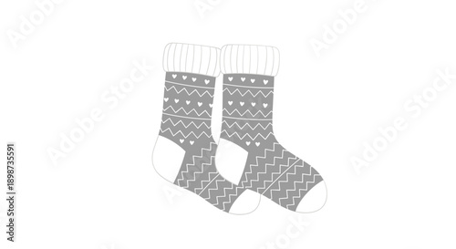 Pair of cozy grey winter socks decorated with white heart patterns and zigzag lines for warmth and comfort during cold weather.