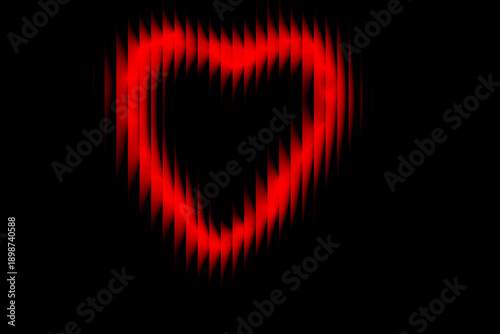 A bright red heart shape glows on a dark black background, symbolizing love and passion.