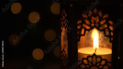 Ramadan lantern with candle flame in cinematic warm glow and bokeh
