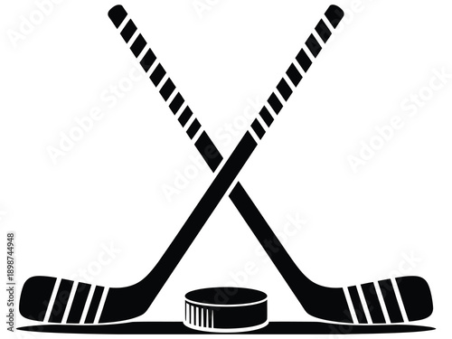 Two crossed hockey sticks with a puck in front of them, black vector illustration, suitable for sports, team logos, ice hockey graphics, and athletic design projects.