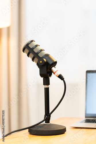 Podcast setup in a home office with a microphone and laptop ready for an interview about education