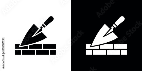 Black and white illustration of a bricklaying trowel on bricks