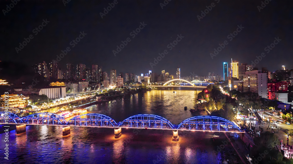 Fototapeta premium Lanzhou Night Cityscape with Illuminated Bridges Over Yellow River