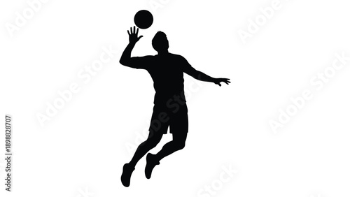 Silhouette of a basketball player mid air preparing to shoot the ball