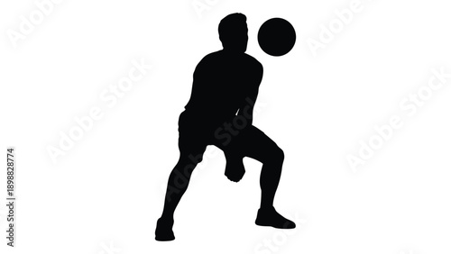 Silhouette of a person playing with a ball appearing to jump or volley