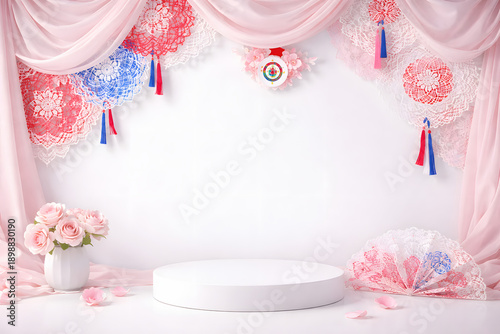 Festive backdrop featuring pink drapery red and blue decorations a white platform and floral accents