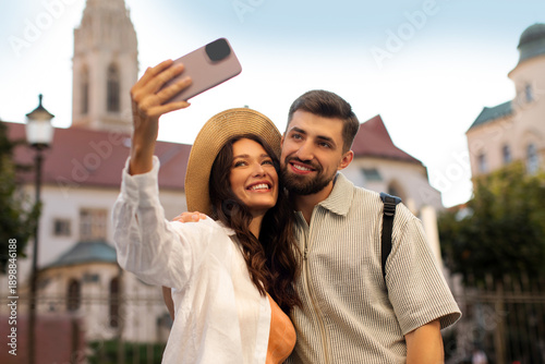 Canvastavla Happy couple taking selfie while exploring the city and enjoying their time as t