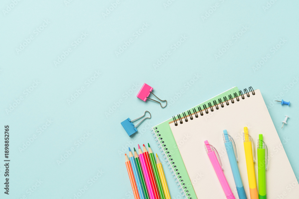 Fototapeta premium School supplies or office stationery on blue background.