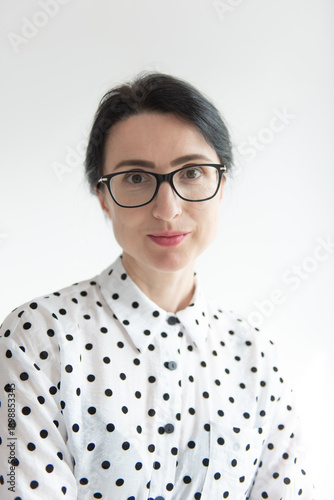 Woman with glasses. A woman with glasses smiling on a white background.  Female student aged 30+