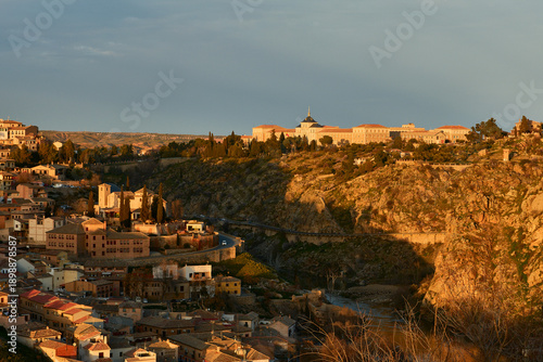Historic Town at Sunset with Large Building on Hill