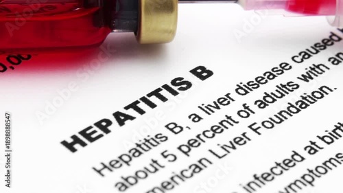 Medical Syringe With Red Liquid Vial Over Hepatitis B Document For Health Care