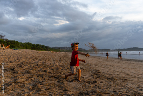 A young boy plays on the beach at dusk in Costa Rica.