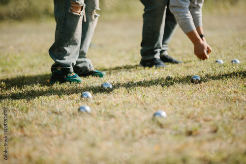 People playing pétanque collection game in park