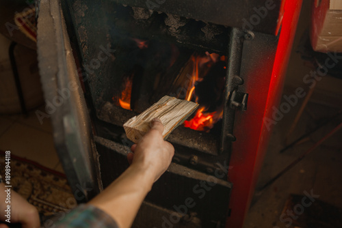Hand fueling wood stove with kindling