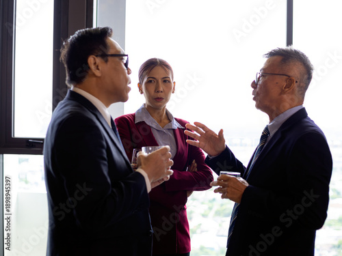 Wallpaper Mural Senior business professionals discussing ideas during corporate break in modern office with city view Torontodigital.ca