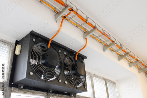 Fotografia Industrial ventilation system featuring dual black fans mounted on a wall with v