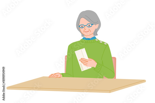 Senior Woman Checking an Envelope at a Desk